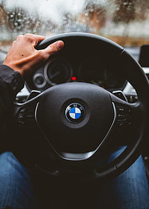 person holding black BMW steering wheel thumbnail