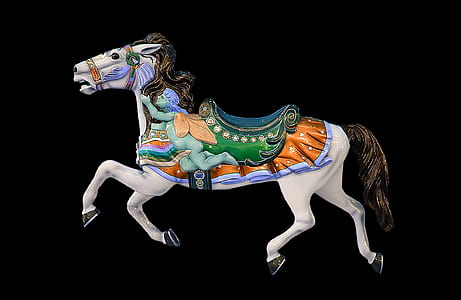 white and brown horse carousel against black background thumbnail
