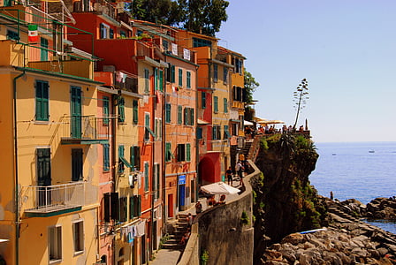 brown and red concrete building near body of water thumbnail