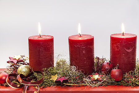 focus photo of three red lighted pillar candles thumbnail