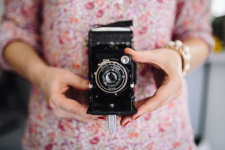 Woman in pink holding miscellaneous items thumbnail