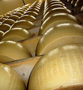 pile of cheese wheel on wooden shelve close-up photo thumbnail