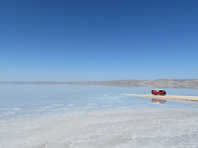 red vehicle on seashore thumbnail