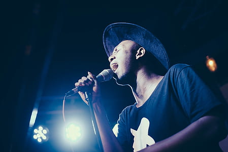 man holding microphone while singing thumbnail