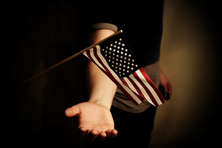 person about to catch falling US flag miniature thumbnail