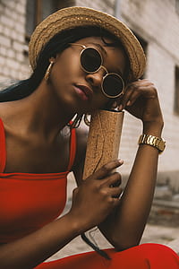 selective focus photography of woman holding brown long wallet while sitting at daytime thumbnail