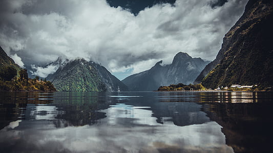 mountain range surrounded with water thumbnail