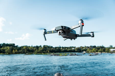 black quadcopter drone flying outdoor during daytime thumbnail