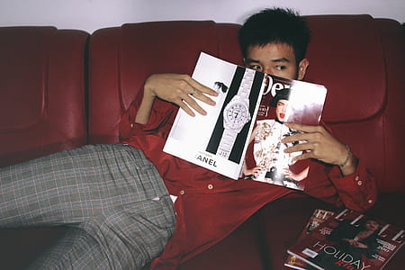 Photography of a Man Holding Magazine thumbnail