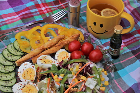egg, cucumber, and bell pepper on plate near yellow cup thumbnail