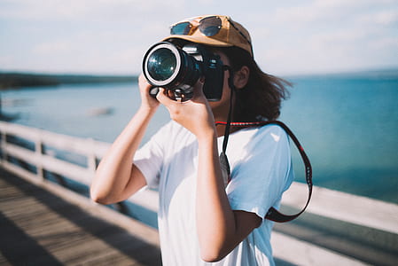 selective photography of woman capturing photos thumbnail