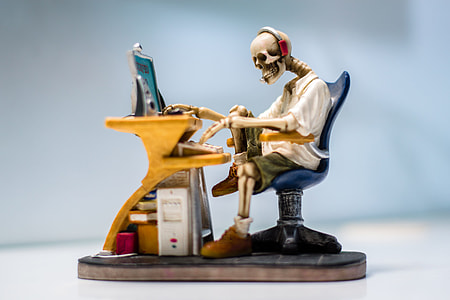 human skeleton sitting on chair in front table figure thumbnail
