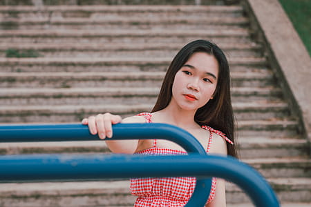 Shallow Focus Photography Of Woman in Red And White Spaghetti Strap Dress thumbnail