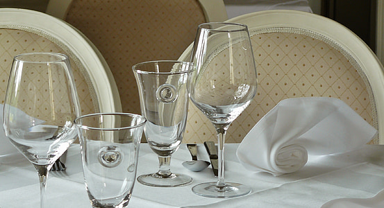 four wine glasses on white table curtain close-up photo thumbnail