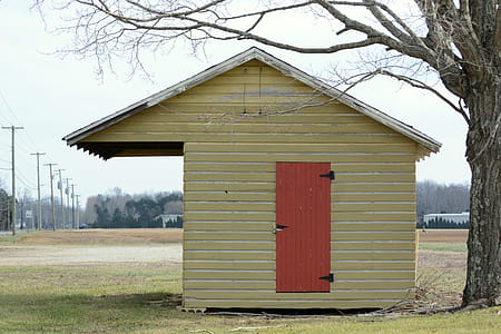 A small building on the side of the road built for selling produce. thumbnail