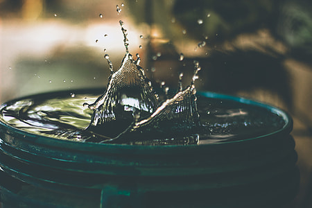 water ripples on top of green plastic bucket thumbnail