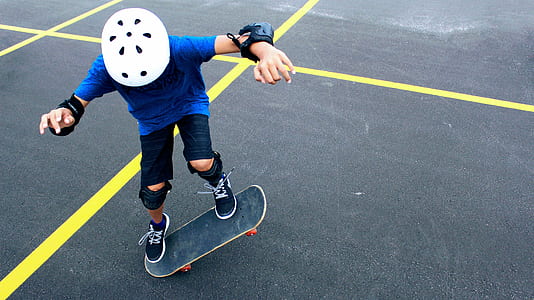boy riding skateboard on parking space thumbnail