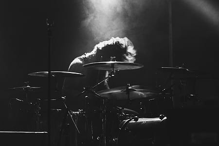 grayscale photography of person playing drums thumbnail