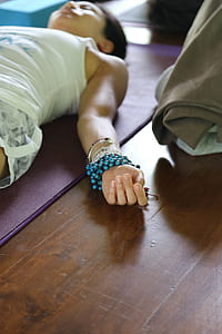 woman lying on purple yoga mat thumbnail