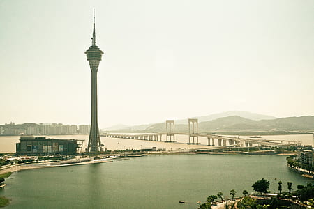 wide angle photo of gray high-rise building near body of water thumbnail