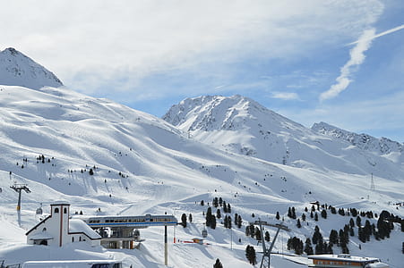 snow covered mountain under cloudy sky thumbnail
