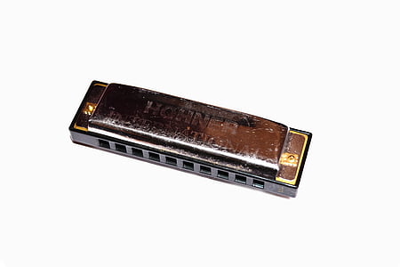 gray stainless steel Hohner harmonica on white surface thumbnail