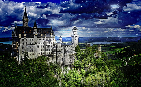 castle on top of hill near green trees thumbnail