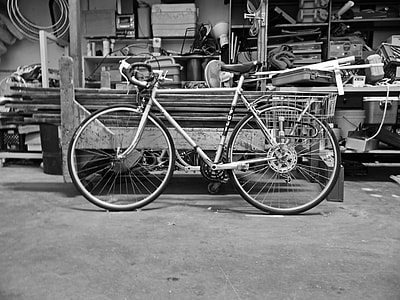 grayscale photo of road bike beside utility trailer thumbnail