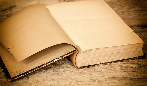 brown book on top of brown wooden surrface thumbnail