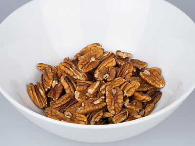 pecan nuts on white ceramic bowl thumbnail