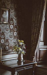 white ceramic flower vase on black wooden table thumbnail