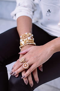 person wearing gold jewelries thumbnail
