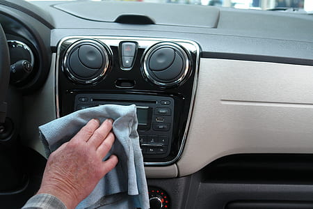 person wiping the car stereo of his car thumbnail