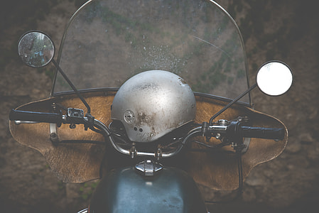 photo of brown and black motorcycle with helmet thumbnail