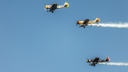 three monoplane flying high with contrails thumbnail
