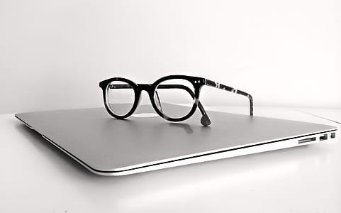 Black Frame Eyeglasses on Silver Macbook Air thumbnail