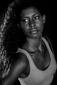 black haired woman wearing white tank top thumbnail