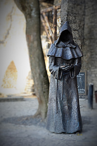 focus photography of man in black robe statue thumbnail