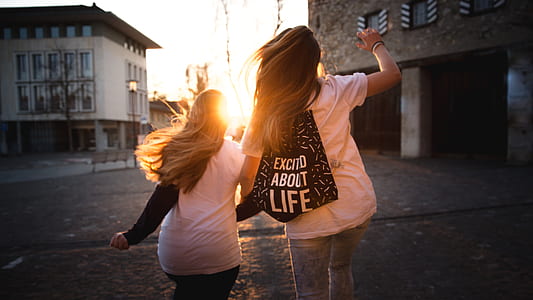 two girl running towards the building thumbnail