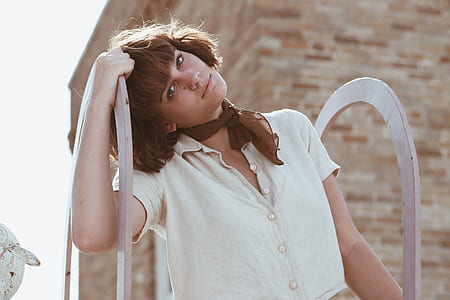 woman wearing beige button-up collared top and brown scarf thumbnail