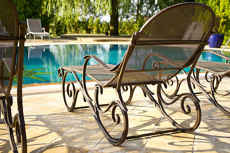 brown pool lounge chair with pool background thumbnail