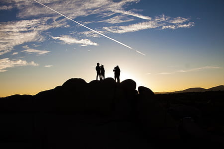 Silhouette Photo of People on Top of Rock Formation thumbnail