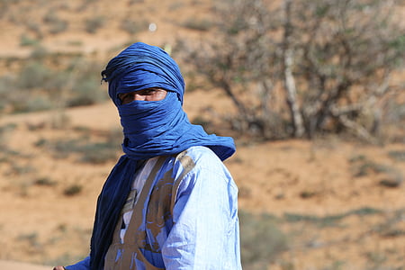 macro photography of man in blue hijab thumbnail