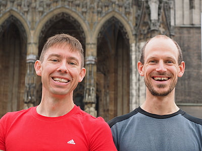 two men standing near building thumbnail
