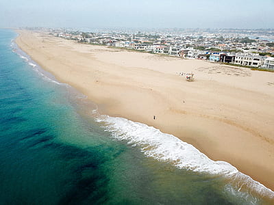 birds eye view of shore near body of water thumbnail