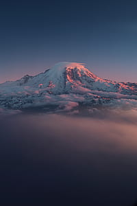snow-capped mountain extending above clouds thumbnail