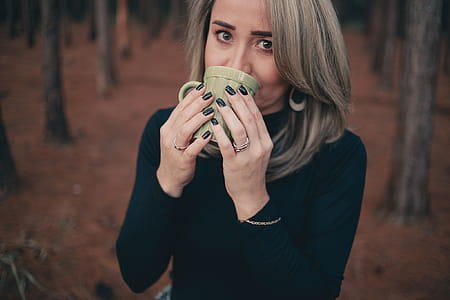 Woman Holding Grey Ceramic Mug thumbnail