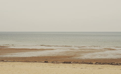 body of water under cloudy sky thumbnail