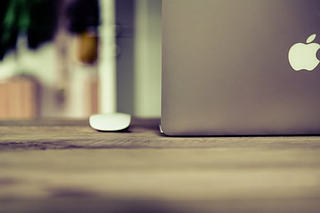 opened silver MacBook on wooden surface thumbnail