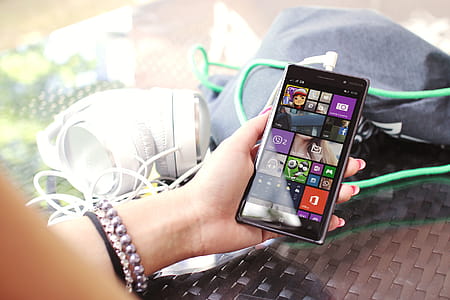 Modern smartphone in hand over glass table thumbnail